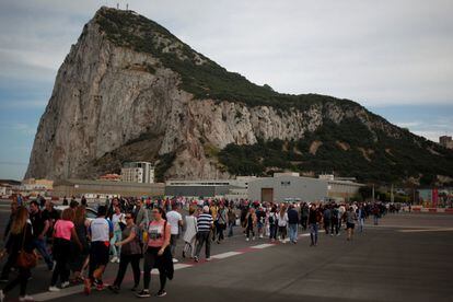 Pedestrians cross the runway at Gibraltar airport.