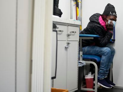 A woman sits before being treated inside a Baltimore City Health Department RV, Monday, March 20, 2023, in Baltimore.