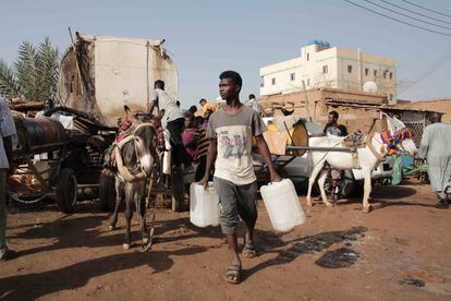 People gather to collect water in Khartoum, Sudan,