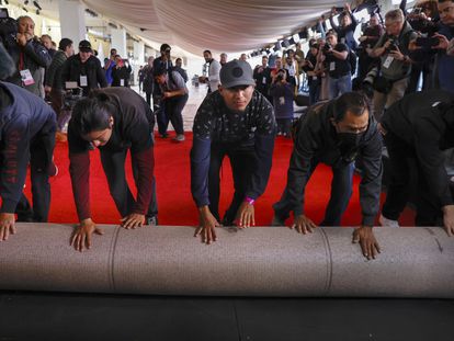Workers roll out the red carpet for the 96th Oscars at the Dolby Theatre on Hollywood Boulevard in Los Angeles on Wednesday, March 6, 2024.