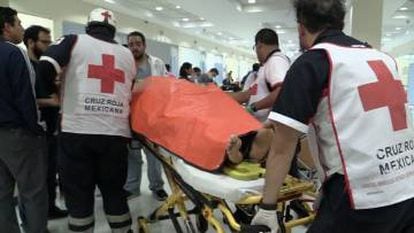 The Mexican Red Cross carrying one of the injured at the Tultepec market.
