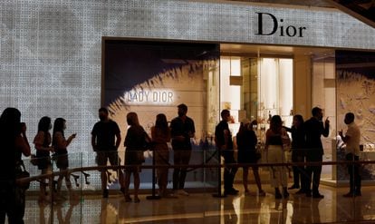 People form a line outside a Dior store in Singapore as the city state reopens the economy amid the coronavirus disease (COVID-19) outbreak, June 19, 2020.