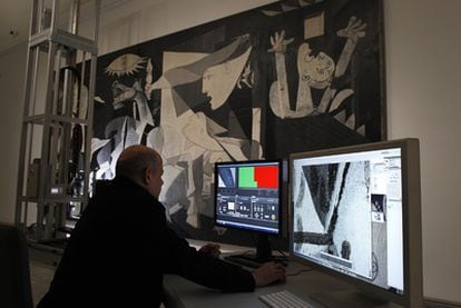 An operator views images of Guernica taken by the robot in the Reina Sofía.