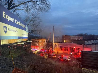 A general view shows smoke coming out from a chocolate factory after fire broke out, in West Reading, Pennsylvania, on March 24, 2023.