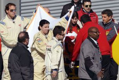 Alonso is taken from the circuit on a stretcher.