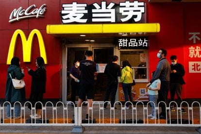 People wait for their orders outside a McDonald's restaurant in Beijing.