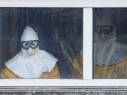 Medical staff in full protective suits treat Ebola patient Teresa Romero on the sixth floor of Carlos III Hospital in Madrid.