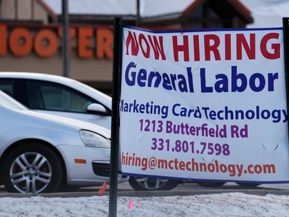 File - A hiring sign is seen in Downers Grove, Ill., Thursday, May 5, 2022. On Thursday, the Labor Department reports on the number of people who applied for unemployment benefits last week.