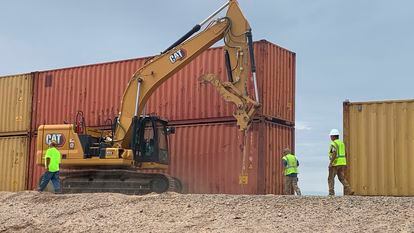 Workers pile up containers near Yuma, Arizona.