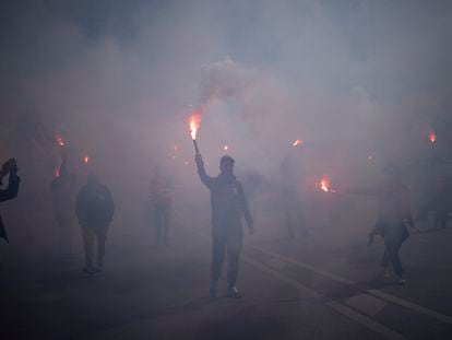 Protesters march with flares during a demonstration in Marseille, southern France