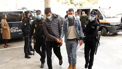 Two of the arrested passengers are brought before a judge in Palma on Monday.