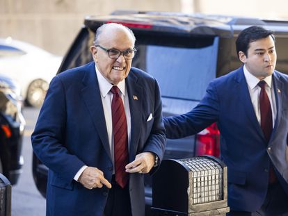 Rudy Giuliani (L) arrives to the US District Court for jury selection in his defamation case brought by two Fulton County election workers in Washington, DC, USA, December 11 2023.