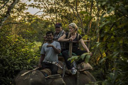 Veterinarian Deborah McCauley and Bishnu Lama on an elephant in Chitwan.