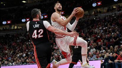 Chicago Bulls' Zach LaVine (8) goes up for a shot against Miami Heat's Kevin Love (42) during the first half of an NBA basketball game, Saturday, March 18, 2023 in Chicago.