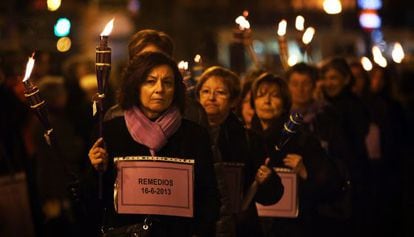 A group of women carries 77 torches in memory of the victims of gender violence in Spain last year.
