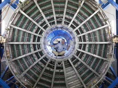 A technician inspects the inside of one of the LHC's detectors.
