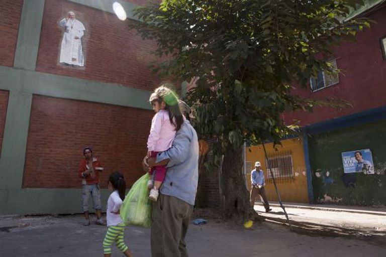 An image of Pope Francis on a building wall inside the 1-11-14 slum.