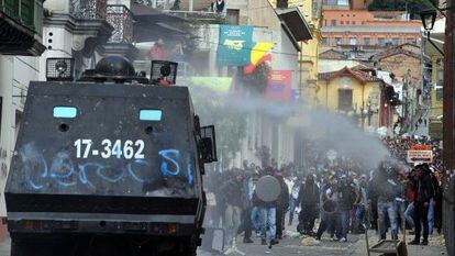 Riot police tanks try to disperse protesters with a water cannon during clashes which erupted after a march in support of Colombian farmers protesting in demand of government subsidies and greater access to land, in Bogota on August 29.
