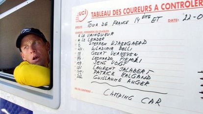 Lance Armstrong looks from the window of a doping control van during the 2001 Tour de France. 