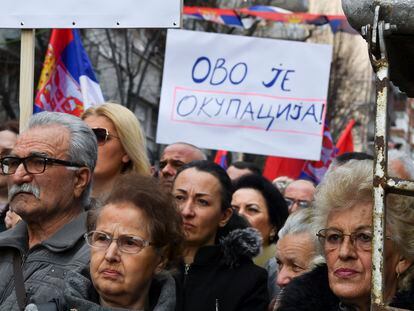 An ethnic Serb holds a placard that reads 'This is an occupation' during a protest against Kosovo's Central Bank decision to enforce Euro-only cash transactions, in Mitrovica, Kosovo, February 12, 2024.