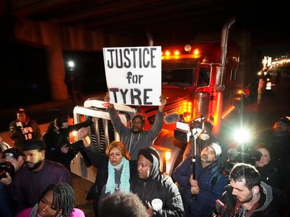 Protesters march down the street Friday, Jan. 27, 2023, in Memphis, Tenn., as authorities release police video depicting five Memphis officers beating Tyre Nichols.