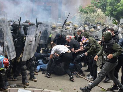 NATO Kosovo Force soldiers clash with local Kosovo Serb protesters at the entrance of the municipality office in Kosovo