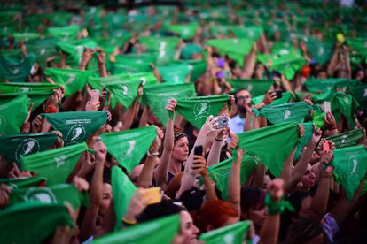 Hundreds of women raise their green handkerchiefs during a pro-choice rally in Argentina in 2020.