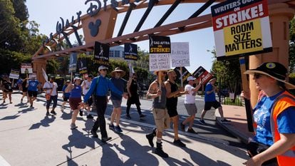 SAG-AFTRA actors and Writers Guild of America (WGA) writers walk the picket line outside Disney Studios in Burbank, California, on July 25, 2023.