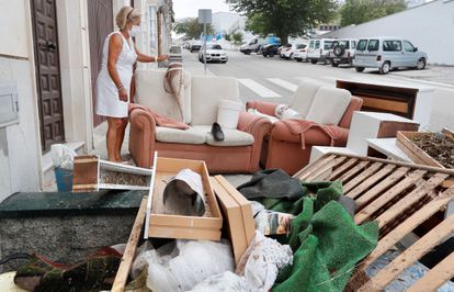 A resident of Estepa with her furniture on the street after Tuesday's extreme weather event. 