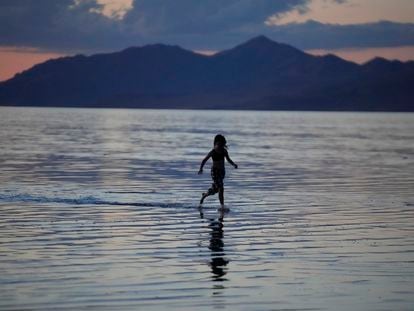 A young person runs through the Great Salt Lake on June 15, 2023, near Magna, Utah