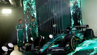 A handout picture released by Aston Martin shows the team's Formula 1 drivers Fernando Alonso (L) and Lance Stroll standing with the Aston Martin AMR23 Formula One racing car for the 2023 season, during its unveiling at their headquarters in Silverstone on February 13, 2023.