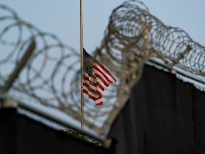 A flag flies at half-staff in honor of the U.S. service members and other victims killed in the terrorist attack in Kabul, Afghanistan, as seen from Camp Justice in Guantánamo Bay Naval Base, Cuba.