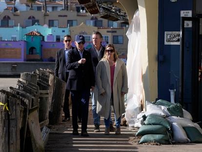 President Joe Biden walks on the boardwalk with Jill Ealy and California Gov. Gavin Newsom as he visits with business owners and local residents in Capitola, Calif., Thursday, Jan 19, 2023, to survey recovery efforts following a series of severe storms.