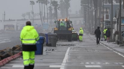 Workers begin to clean up debris from a storm, in Oceanside, California, U.S., February 6, 2024.