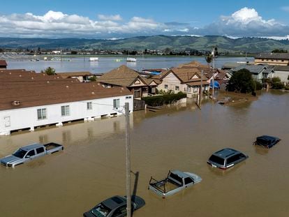 Floodwaters surround homes and vehicles in the community of Pajaro in Monterey County, California
