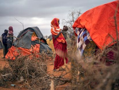 A Somali woman breastfeeds her child at a camp for displaced people on the outskirts of Dollow, Somalia in September 2022.