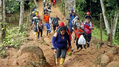 Venezuelan migrants climb a mountain to reach Panama, in the Darién Gap (Colombia), on October 8, 2022.
