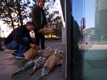 People leave flowers at the Brussels bank headquarters where two Swedish fans were killed by a gunman on Monday.