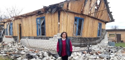 Natalia Ribachok in front of her house which was badly damaged by the impact of a projectile.